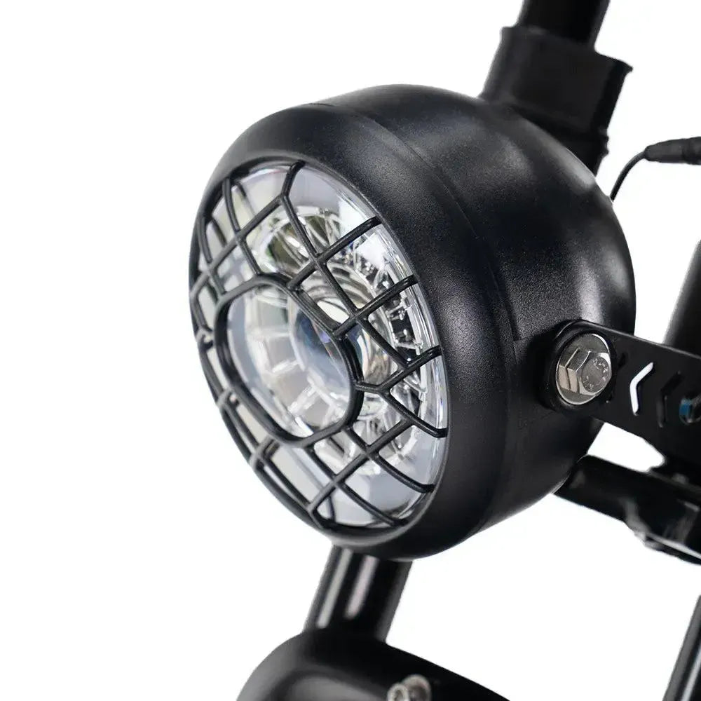 Ouxi V8 2025 fatbike in black, detail of the round LED headlight with black protective grille