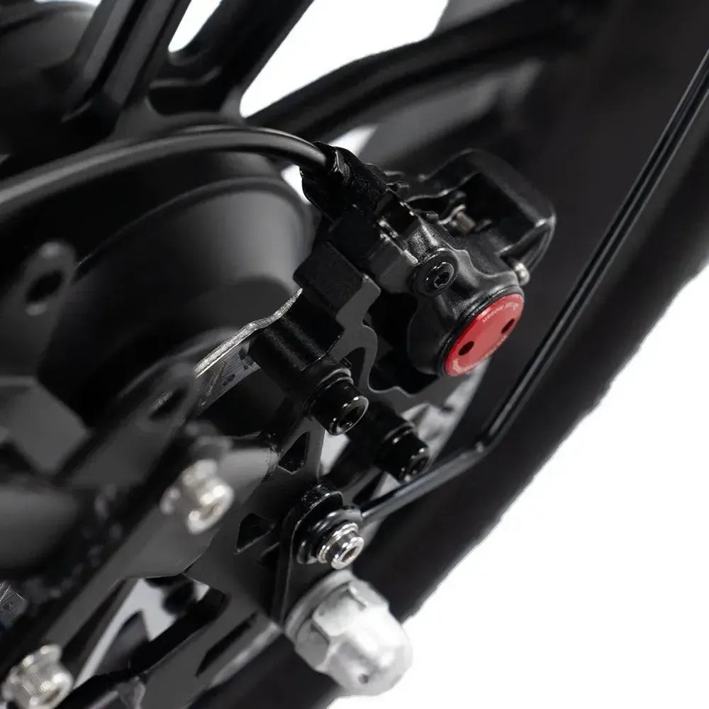 Ouxi V8 2025 fatbike in black, detail of the disc brake with brake caliper at the wheel
