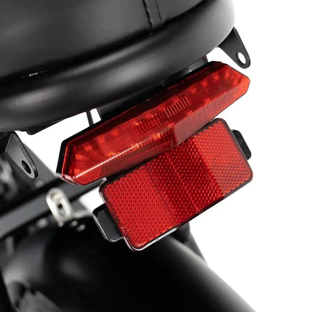 Ouxi V8 2025 fatbike in black, detail of the red rear light with reflector under the saddle